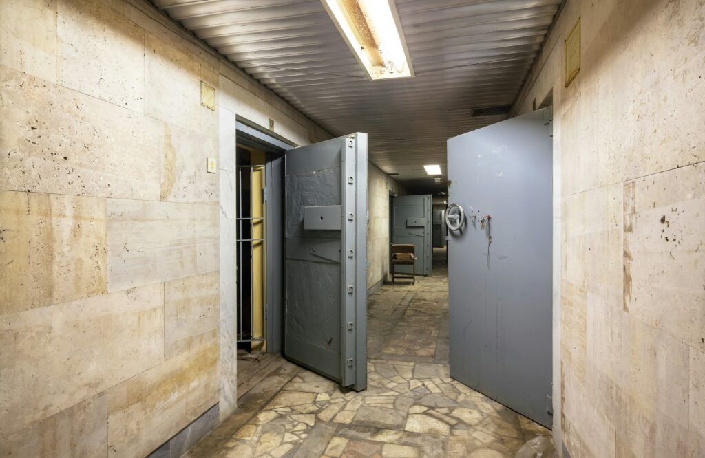 Corridor with open armored doors in an abandoned financial institution
